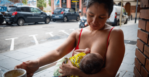 woman breastfeeding child in public
