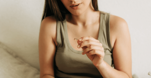 woman holding a pill