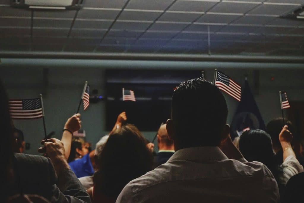 people holding small us flags
