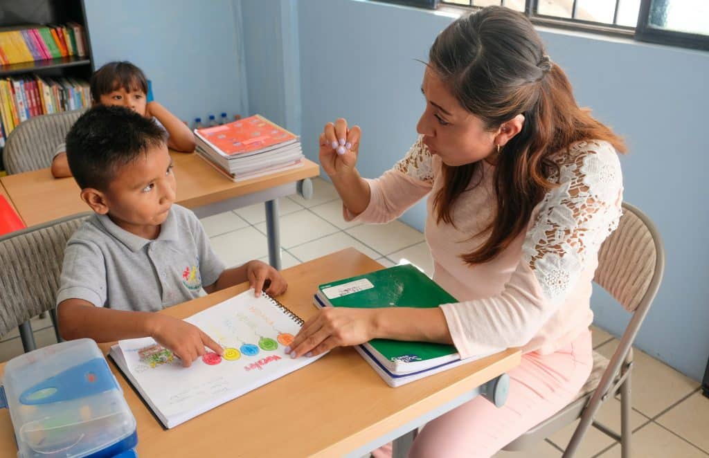 teacher showing colors to child student