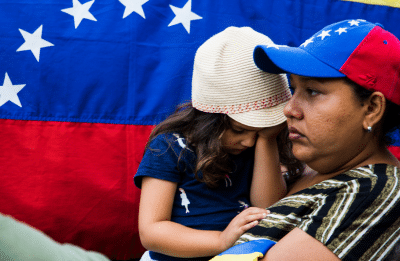 woman holding her child looking defeated