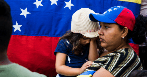woman holding her child looking defeated