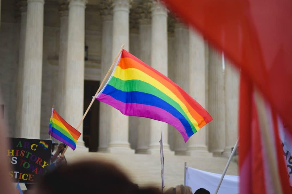 rainbow flag waving in front of building