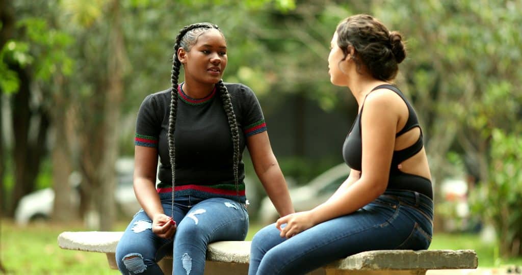 two young women talking outside