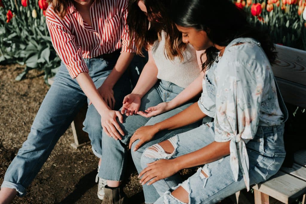 two women comforting a third woman