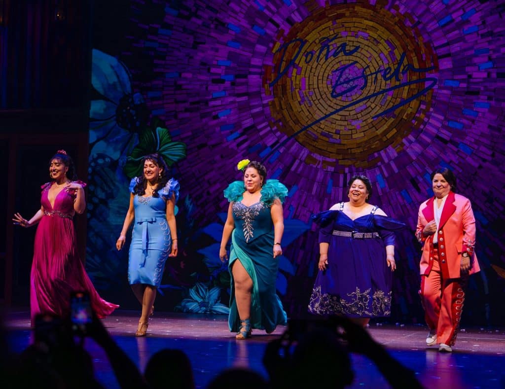 women standing on stage