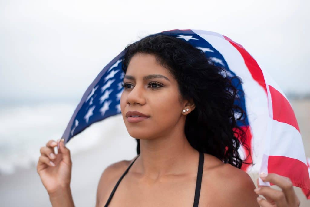 woman holding us flag over her head