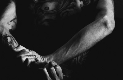 man with hands behind his back