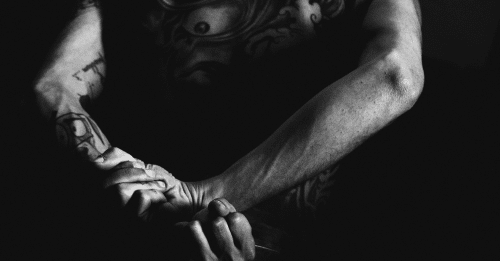 man with hands behind his back
