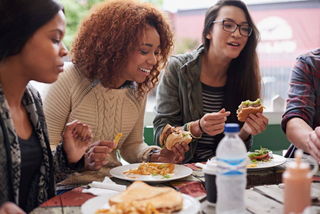 group of friends eating burgers