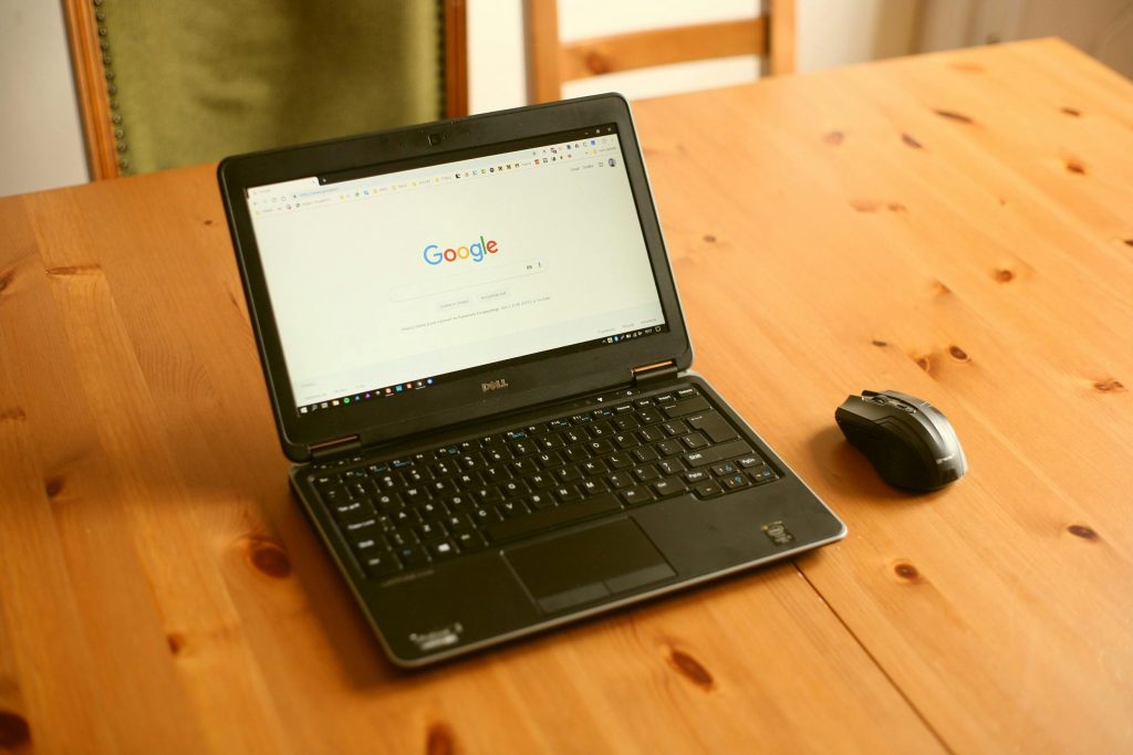 laptop on table with google page open