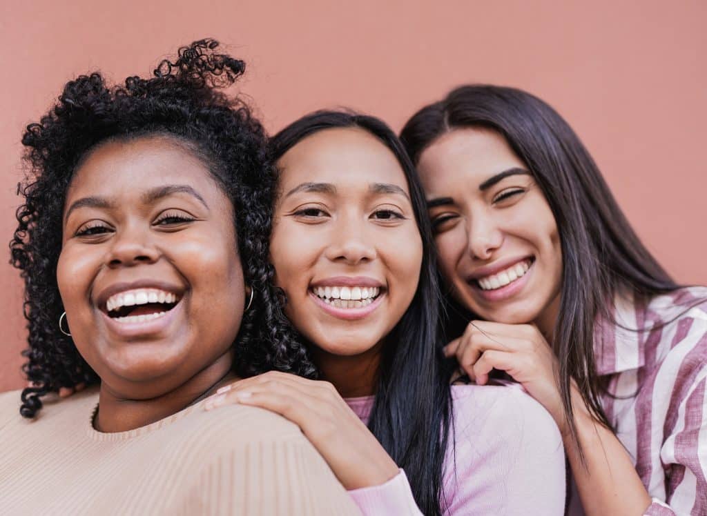 three women posing together