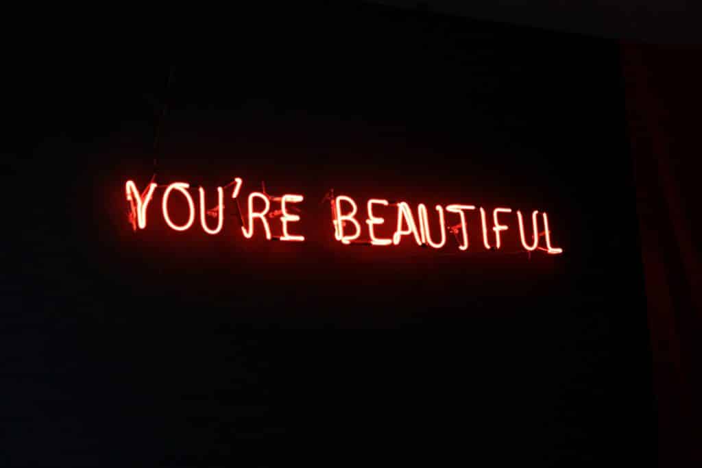 neon sign that reads you're beautiful