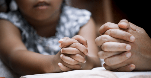 close up of little girl praying