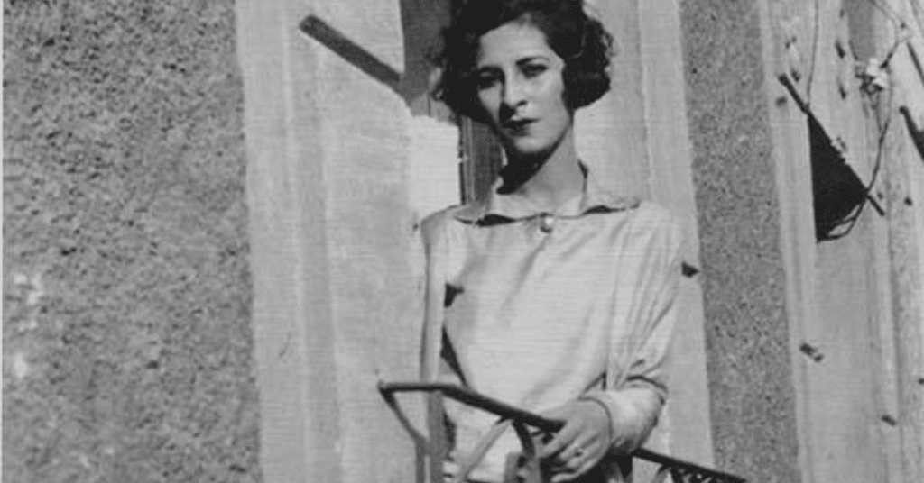 old photo of woman standing on balcony