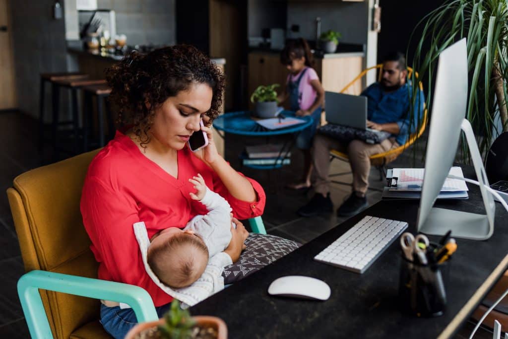 mother working with baby on her lap