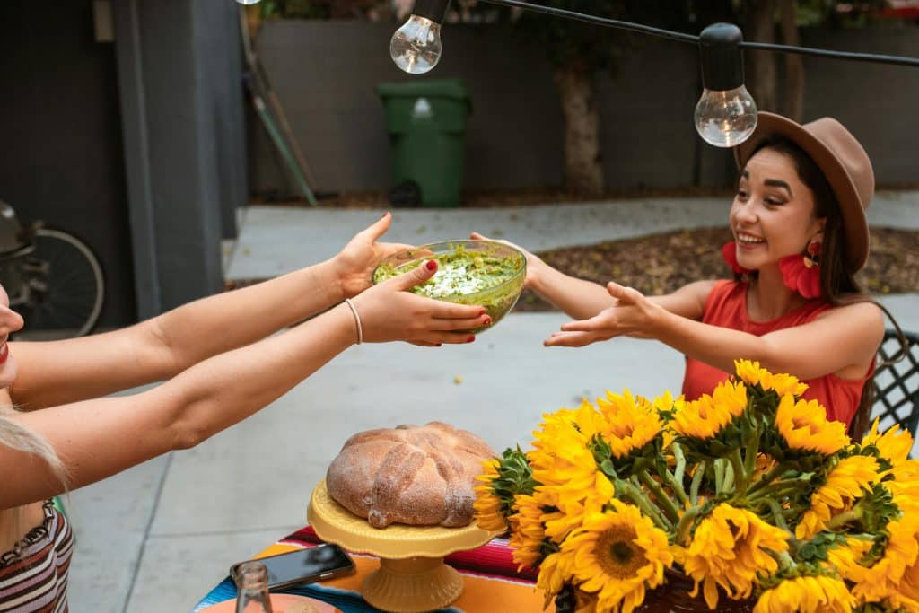 women sharing a bowl of guacamole