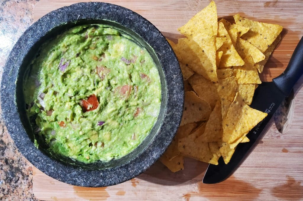 close up of guacamole and chips