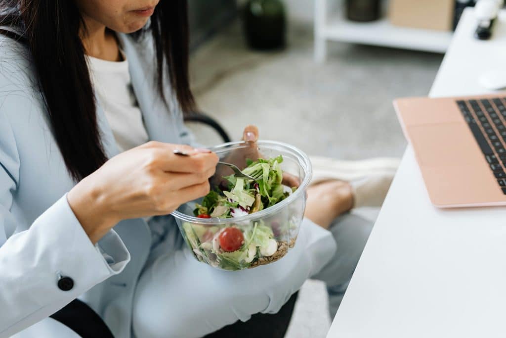 woman eating at her desk