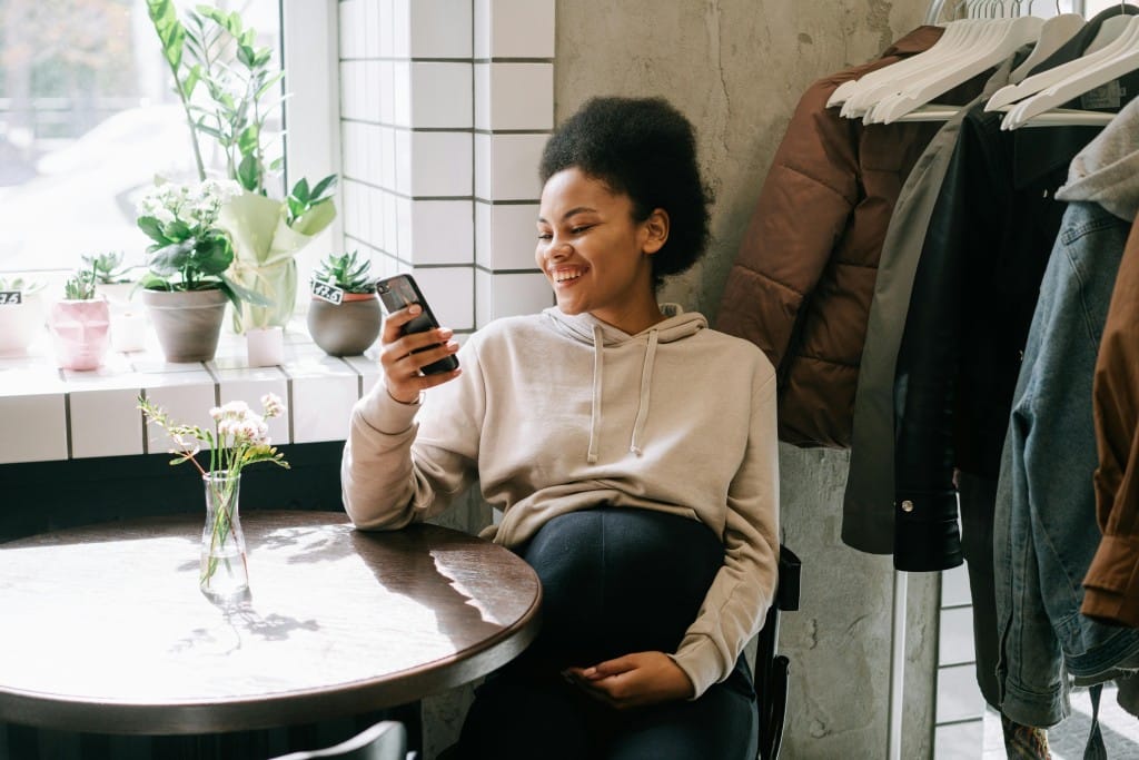 woman smiling at her phone