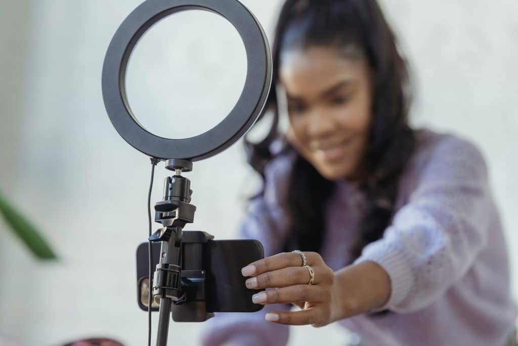 woman setting up camera to record