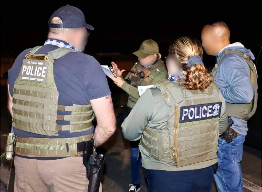 officers gathered taking notes