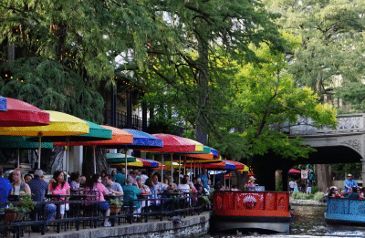 people sitting at cafes on the river walk
