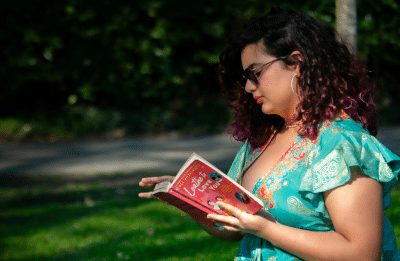 woman reading a book outside