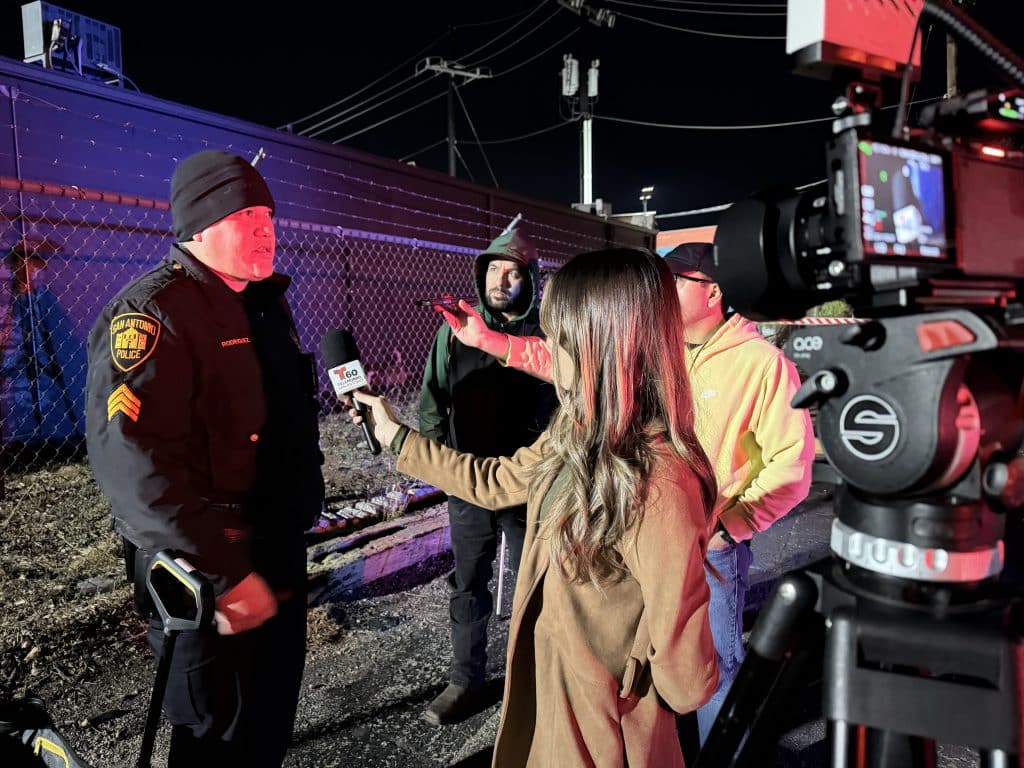 woman interviewing man outside