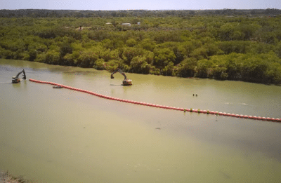Construction of a floating barrier in the Rio Grande near Eagle Pass as part of Texas's Operation Lone Star. The image was taken by a CBP drone.