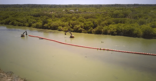 Construction of a floating barrier in the Rio Grande near Eagle Pass as part of Texas's Operation Lone Star. The image was taken by a CBP drone.