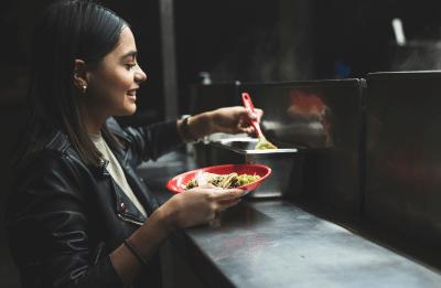 woman smiling with a taco in hand