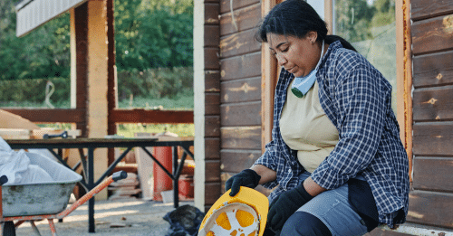 woman in construction worker gear sitting down