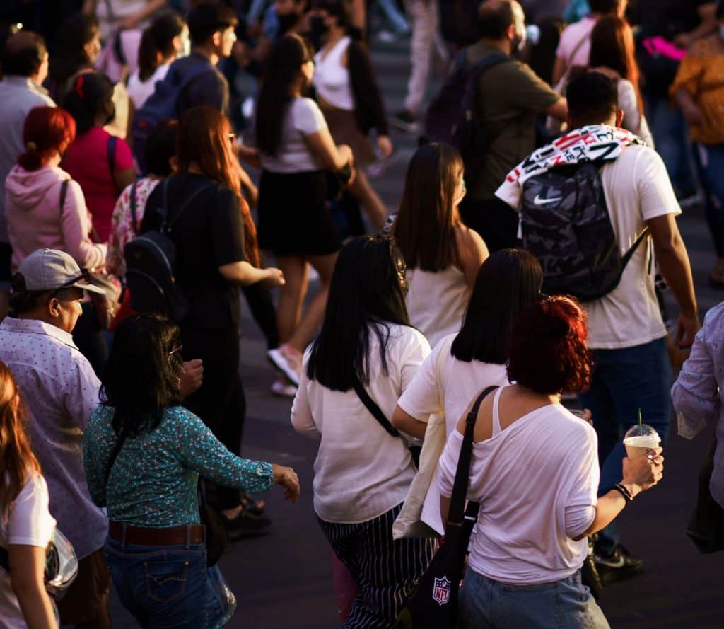 Vibrant urban scene at a bustling intersection filled with diverse pedestrians crossing