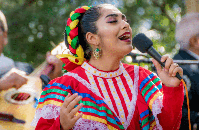woman singing holding a mic