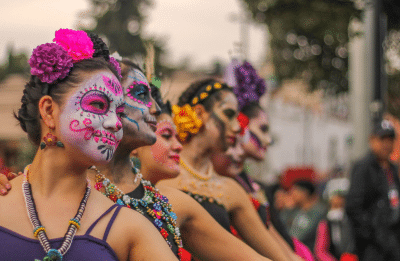 Festive dancers celebrate Day of the Dead with vibrant makeup and costumes