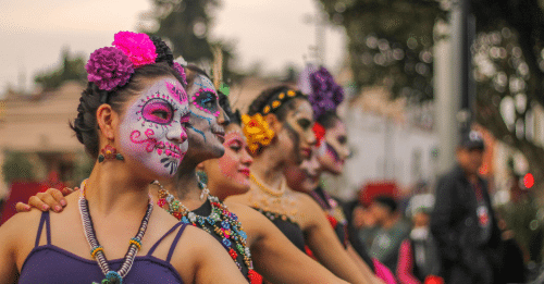 Festive dancers celebrate Day of the Dead with vibrant makeup and costumes