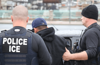 immigration enforcement officers detaining a man
