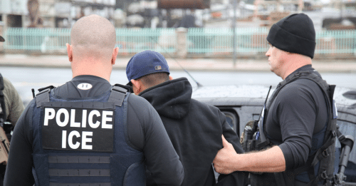 immigration enforcement officers detaining a man